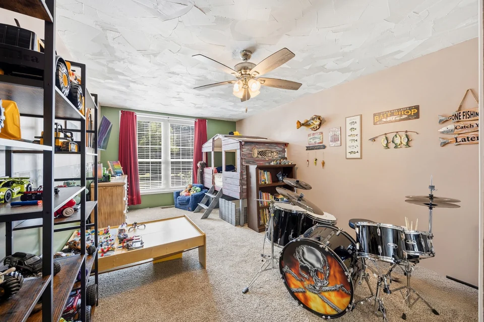 Bedroom with bed and drum set