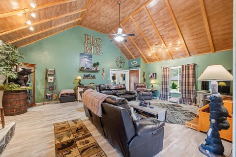 Living room with vaulted wood ceiling and seating