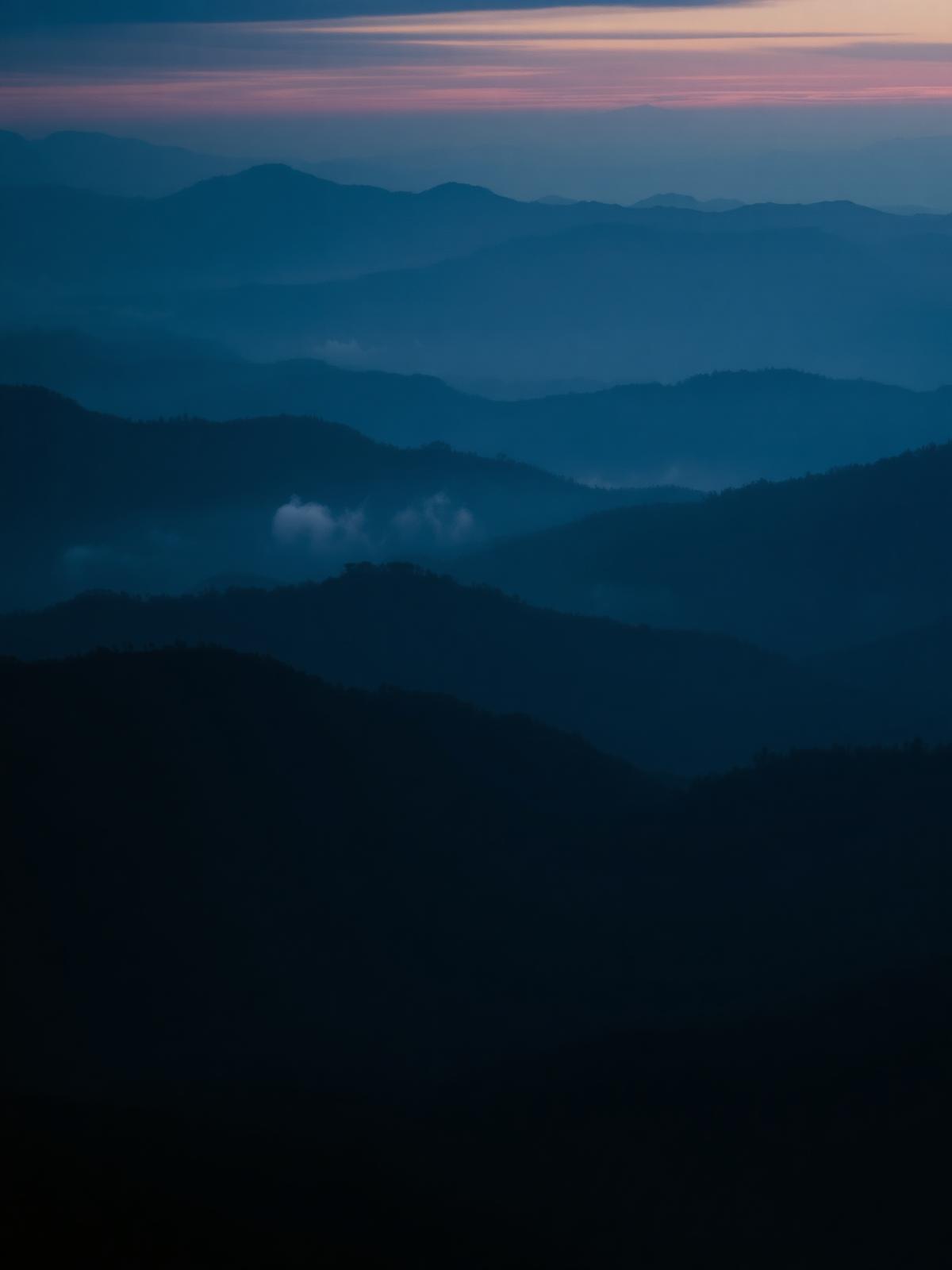 Aerial view of the Great Smoky Mountains at dawn, misty layered ridges over Pigeon Forge and Gatlinburg